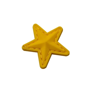 Detail of a bright yellow star PVC patch with embossed faux stitching on a clean white background