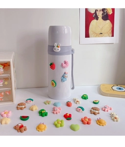 Close-up of DIY 3D cartoon resin charms on a minimalist white thermal water bottle