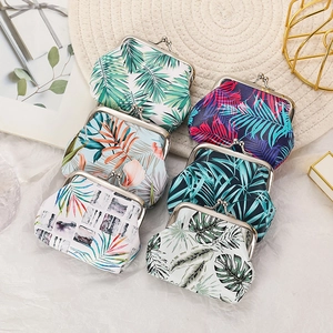 Overhead view of various coin purses with colorful tropical leaf patterns and metal clasps