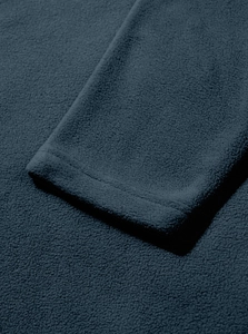 Close-up of the deep blue fleece fabric showing soft texture and premium sleeve stitching