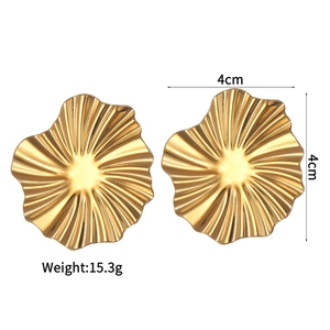 Macro detail of 4cm gold earrings with irregular ripple texture and size markings