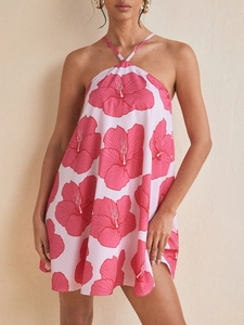 Pink halter neck mini dress with fuchsia hibiscus floral print and flowing A-line skirt