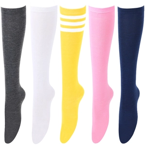 Detail shot of knee-high striped socks showing textures in gray, white, yellow, pink, and navy