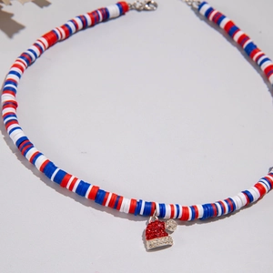 Detailed macro view of colorful polymer clay beads with a sparkling rhinestone Santa hat charm