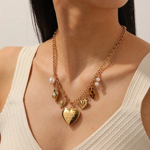 Collier vintage en acier inoxydable doré avec médaillon cœur ouvrant et pendentif soleil