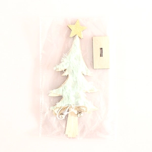 Detail of DIY wooden Christmas tree with green faux fur, gold star and rustic bell