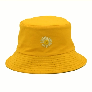 Bright yellow cotton bucket hat with white daisy embroidery and stitched brim detail