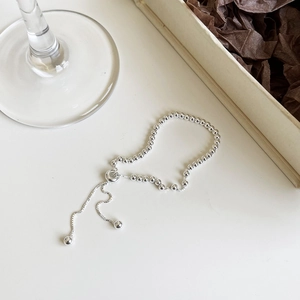Adjustable S925 sterling silver bead bracelet on white surface with gift box background