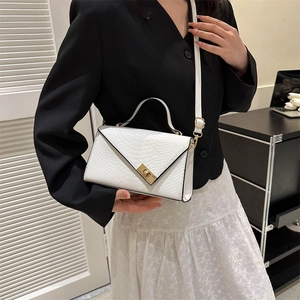 White crocodile embossed leather flap bag with gold lock and adjustable strap