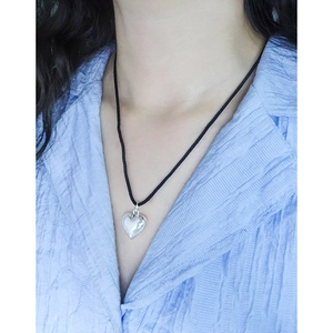 Minimalist S925 silver heart pendant on a thin black cord necklace worn by a model