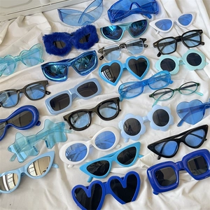 Polygonal cat-eye and heart-shaped sunglasses collection in blue and white tones