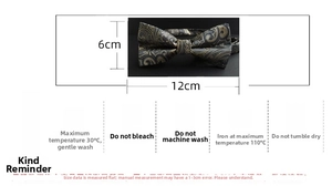 Macro shot of dark grey and gold paisley bow tie with detailed care instructions