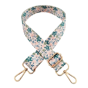 Adjustable floral bag strap with pink and green flowers and gold metal clasps