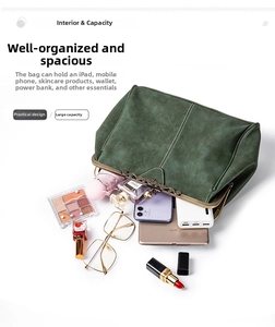 Top view of green matte leather handbag interior showing storage for phone and makeup
