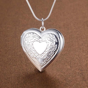 Silver plated heart locket pendant with floral engravings on a sleek snake chain necklace