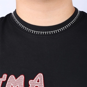 Silver necklace with fine chain and vertical bar pendants on a model wearing black