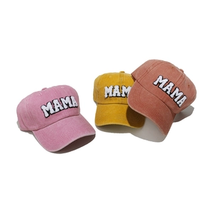 Three washed cotton baseball caps with MAMA chenille embroidery in pink, yellow and red