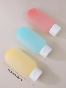 Detailed size view of 60ml soft silicone travel bottles in pastel pink, blue, and yellow