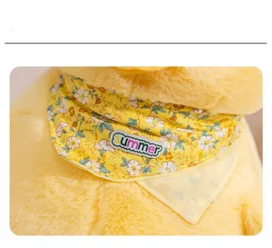 Close-up of yellow plush duck featuring a floral scarf with Summer embroidery detail