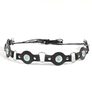 Detail of vintage black leather belt with turquoise stone sunburst buckles and chain link