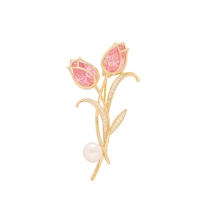 Detail of luxury tulip brooch with pink gems, sparkling crystals, and a pearl drop charm