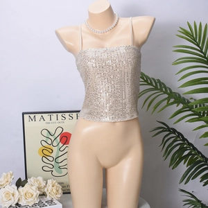 Detail of champagne gold sequin camisole top with thin straps and open back design