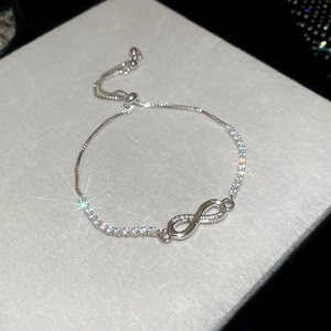 Detail of silver infinity bracelet with zircon stones and adjustable slider clasp