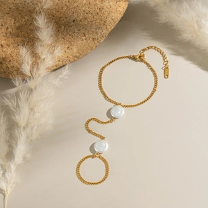 Detail of 18K gold plated stainless steel pearl finger chain with adjustable bracelet