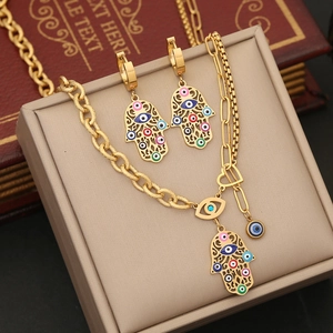 Golden Hamsa hand and Evil Eye jewelry set on display with dual-style chain necklace