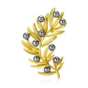Elegant gold olive branch brooch with dark grey pearls on a clean white background
