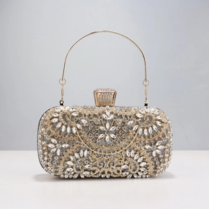 Detailed macro view of luxury gold evening clutch with crystal flower pattern and metal ring