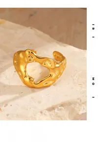 Detailed macro view of 18K gold plated molten lava texture ring on stone surface