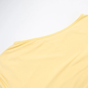 Detail of a pale yellow crew neckline featuring high-density elastic fabric and neat stitching