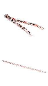 Detail of rose gold magnetic heart link bracelet featuring red black and white decorative points