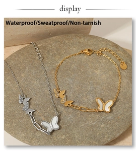 Detailed macro of gold and silver butterfly bracelets with shell and zircon inlay