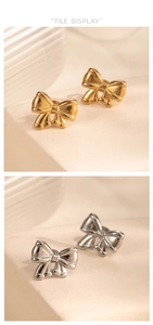 Detailed comparison of polished gold and silver bow stud earrings on a textured surface