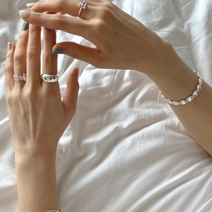 Irregular textured S925 sterling silver rings and coffee bean chain bracelet on hand