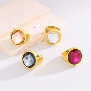 Detail of 22mm wide gold stainless steel rings with large colorful faceted gemstones