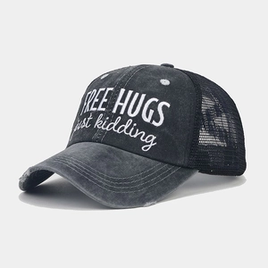 Close-up of vintage washed black mesh ponytail baseball cap with Free Hugs embroidery