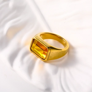 Detailed close-up of a 18k gold plated signet ring with a rectangular yellow gemstone