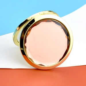 Portable golden makeup mirror with pink crystal gemstone and foldable round metal frame