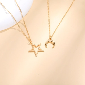 Detailed flat lay of minimalist gold star and crescent moon necklaces for best friends