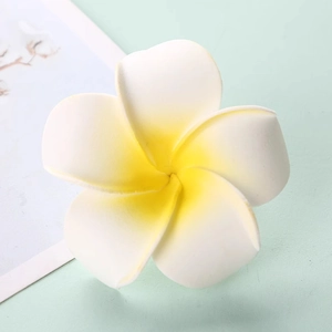 Close-up of realistic EVA foam Plumeria flower with white petals and yellow center