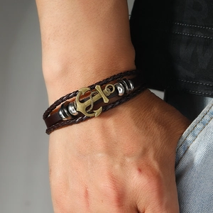 Men's vintage multilayer leather bracelet with a retro brass anchor charm on a male wrist