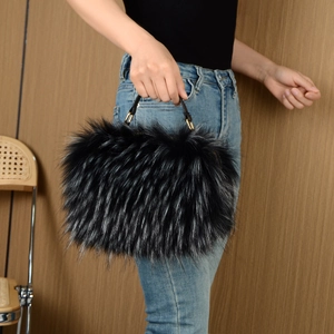 Detail of faux raccoon fur handbag with gradient texture and leather handles
