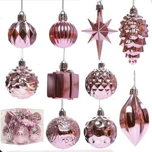 Pink Christmas ornament set with assorted metallic baubles, stars, and pinecones