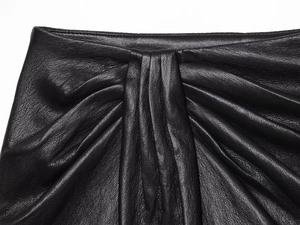 Détail macro du similicuir noir avec texture plissée et finitions de haute qualité