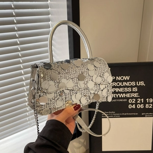 Close-up of sparkling silver sequins and metal chain strap on this stylish handbag