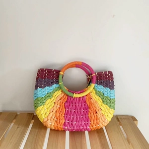 Rainbow woven straw handbag with colorful stripes and round top handles for beach vacation
