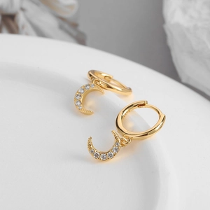 Macro detail of gold moon pendant earrings with S925 silver stamp and zircon micro-paving